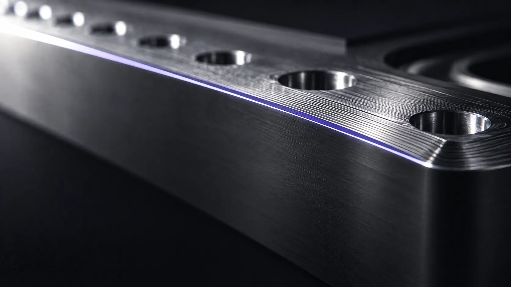 Close-up of machined metal with fine toolpath lines